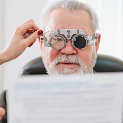 making a selection of lenses, diagnosing a elderly man's vision. medical device. advertising of the clinic, treatment and correction of vision.